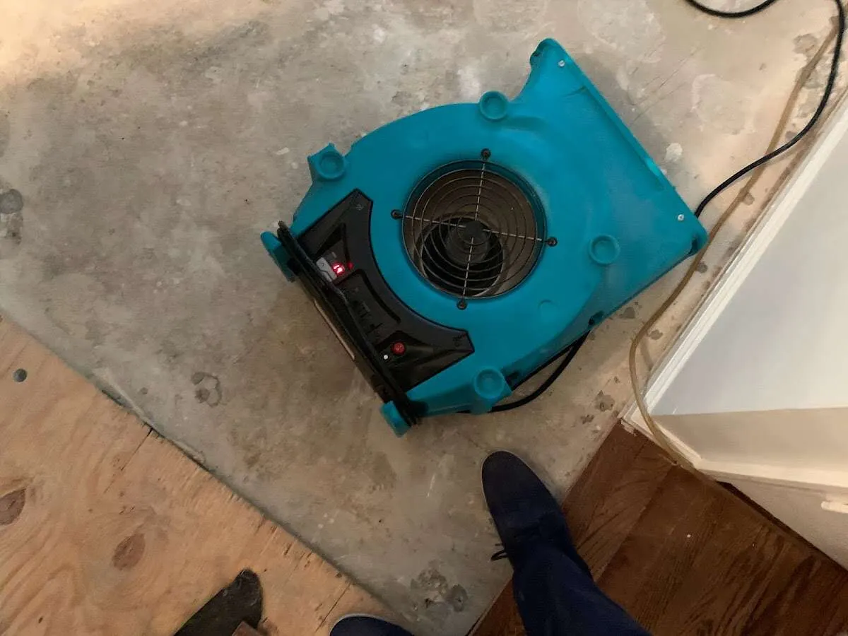 Air mover drying subfloor during Commercial Water Damage Restoration in Barberton